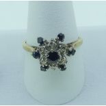 A small sapphire and diamond cluster Ring, the claw set central sapphire set above a surround of six