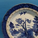 A quantity of Booth's 'Old Willow' pattern Plates, of varying sizes, including two Meat Platters,