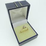 A single stone diamond Ring, the circular stone approx 0.35ct, mounted in 9ct gold with reeded
