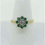 A small emerald and diamond cluster Ring, the central diamond c.0.1ct surrounded by eight
