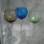 An antique etched glass Decanter, with stopper, together with three etched coloured Glasses (4)