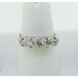 A graduated five stone diamond Ring, the centre stone c¼ct., all mounted in unmarked white metal,
