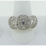 A diamond triple Cluster Ring, the central cluster formed of a circular diamond approx. ½ct,