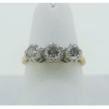 A three stone diamond Ring, the central circular cut stone approx 0.35ct with a smaller stone on