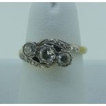 A diamond three stone crossover Ring, the centre stone approx 0.25ct with the outside stones