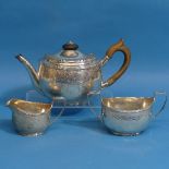 A Victorian silver three piece Tea Set, by Robert Harper, hallmarked London 1881, of small oval
