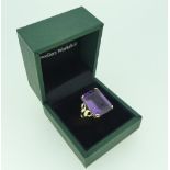 A large amethyst Dress Ring, the emerald cut stone approx 17.2mm x 13.2mm, c.13ct, in an unmarked