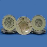 A matched collection of eight Susie Cooper Plates, decorated in abstract swirl, numbered 678,