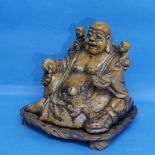 A soapstone carving of a seated Buddha, raised on fitted wooden stand, H cm