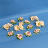 A quantity of continental porcelain Table Decorations, modelled as flowers, including some