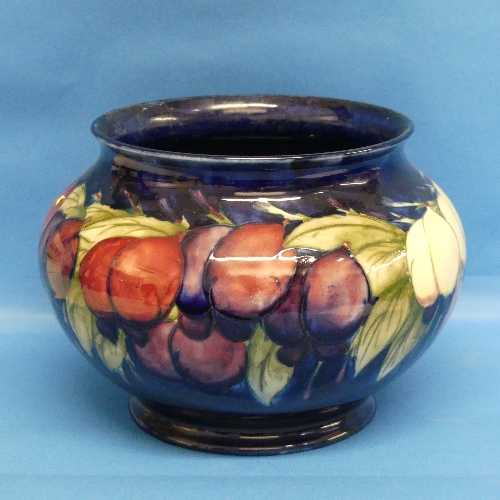 A Walter Moorcroft 'Plum Wisteria' pattern Bowl, in typical tube-lined decoration, repaired to
