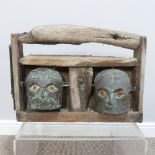 A contemporary driftwood and Verdigris metal Garden Sculpture, formed of two moving male heads,