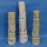 A trio of modern chimney-like Vases, in pale green shades, with tube lined decoration, the tallest