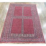 Tribal Rugs: a red ground Pakistan hand knotted Rug, wool on cotton, the whole finely woven with