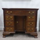 A George III-style mahogany Kneehole Desk, the top with some pieced-in veneer, W 93cm x H 77.5cm x D