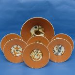 A Royal Copenhagen mid 20thC porcelain Dessert Service, each in coral ground with central fruit or