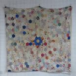 An early 20thC hand-stitched Patchwork Quilt, formed of hexagonal pieces of fabric each 9.5cm,