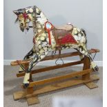 An early 20thC dapple-grey Rocking Horse by Collinson, in need of restoration, L 138cm x H 117cm x D