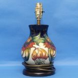 A Moorcroft pottery 'Anna Lilly' pattern Lamp and Shade, on fitted wooden plinth, with mark to base,