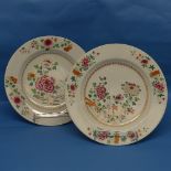 A near pair of 18thC Chinese porcelain famille rose Plates, decorated in flora, one with crack, 35cm