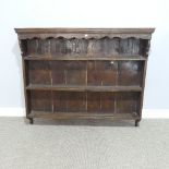 An Antique style oak wall mounted Plate Rack, W 130cm x H 110cm x D 21.5cm.