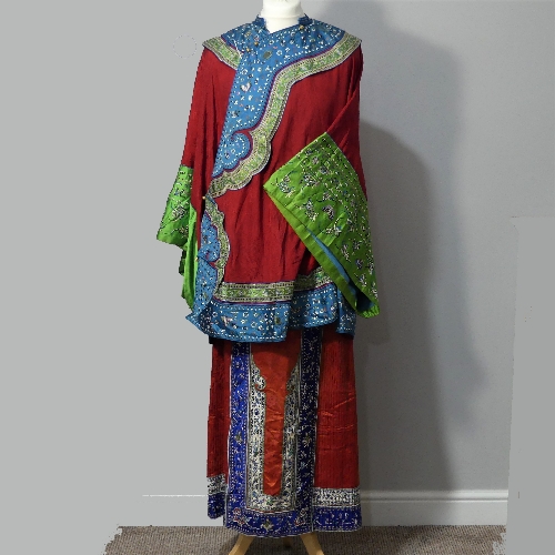 An early 20thC Chinese figured red silk Wedding Robe, edged with contrasting fabric and shaped