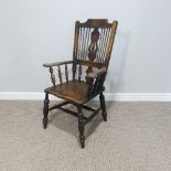 An early 20thC spindle and splat back Country Chair, with carved back and double stretcher.