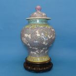 A Chinese Republican period porcelain Temple Jar and Cover, decorated in enamels of purple, blues