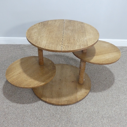 A Heals limed oak circular Book Table, circa 1930's, with two swing out circular tiers, the top with