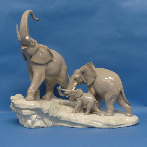 A Lladro figural Group of Elephants, modelled as three elephants, the largest with broken tusk,