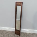 An Arts & Crafts copper framed rectangular Mirror, of narrow proportions, with stylised motifs, W