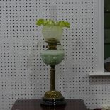 An antique brass and pressed pale green glass Oil Lamp, 71cm high.
