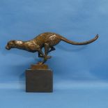 An Art Deco style bronze figure of a running Cheetah, on black marble base, W 30.5cm x H 19cm.