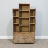 A Heals style limed oak Bookcase, circa 1930's, with open shelves in a stepped symmetrical