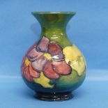 A Moorcroft 'Hibiscus' pattern squat Vase, tube lined design in the typical style, sticker to