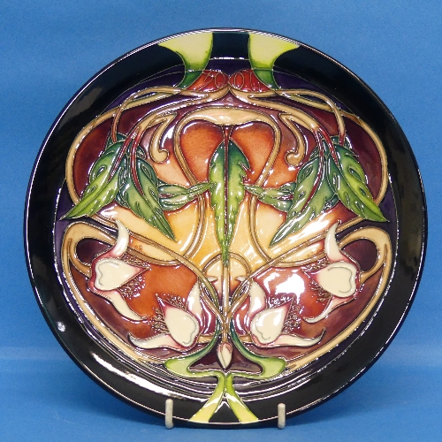 A limited edition Moorcroft pottery 'Swan Orchid' pattern Plate, designed by Emma Bossons, number
