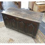 An 18thC oak Coffer, the front with four Gothic-shaped arched panels, one side with a rectangular