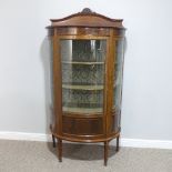 An Edwardian inlaid mahogany bow-front Display Cabinet, the curved door opening to reveal lower