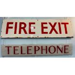 An Enamel Fire Exit Sign, red wording on white background, some rust and wear at edges and fixing