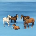 A Beswick matte grey Horse, with dark grey mane, together with a further three Beswick Horses and