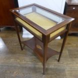 An Edwardian inlaid Bijouterie Table, of rectangular form, with hinged glazed lid, above a shelf