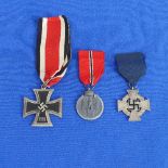 A reproduction WW2 period German Iron Cross, 2nd Class, together with a German Eastern Medal (Medai