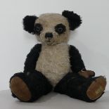 A 1950s Dean`s Rag Book Panda Bear, with amber and black eyes, stitched snout and jointed body