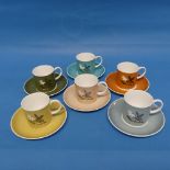A set of six Susie Cooper coffee cans and saucers, decorated in pastel colours with various flowers,