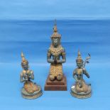 A Tibetan figure of a kneeling High Priest, on stepped wooden base, together with two similar