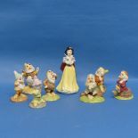 A Royal Doulton set of Snow White and Seven Dwarfs, comprising Snow White SW9, Doc SW10, Grumpy