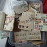 Stamps; An accumulation of Stamps, in old time albums and loose, all contained within a plastic