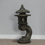 Garden statuary; a reconstituted stone Oriental style pagoda, on an arched support, 88cm high