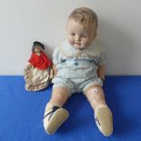 An early wax doll, on cloth body with wax arms, painted face , in original clothes,H 22cm,