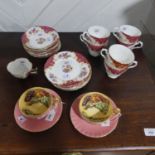A pair of Aynsley 'Orchard Gold' Cups and Saucers, decorated in the Worcester-style Still Life of